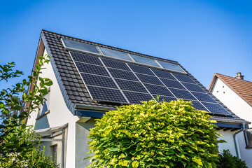 Photovoltaic panels on the roof of family house, solar panels. Environment and technology concepts.