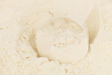 Measuring spoon lying in gluten free flour background.