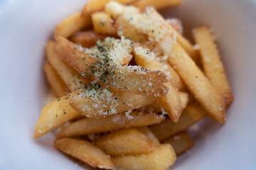 Close-up of French fries with a sprinkling of seasoning that looks delicious. Crispy French fries