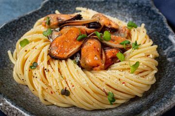 spaghetti with mussels, without shell, pasta with peeled mussels, in carbonara sauce, micro-greens, homemade, no people,