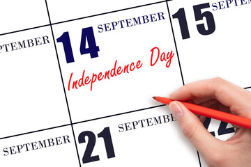 September 14. Hand writing text Independence Day on calendar date. Save the date.