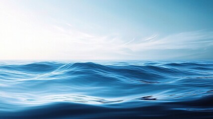 Fototapeta premium Tranquil Ocean Horizon: A vast and serene seascape, painted in soft hues of blue, stretches endlessly beneath a sky kissed by the golden glow of dawn. 