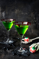 Green witch drink  in glass with blood, Halloween  drink idea