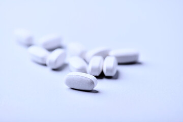 Amino acids tablets. Nutrition for bodybuilding. Fitness supplements on bright background. Soft focus. Copy space.