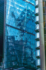 Stunning view of blue glass skyscrapers reflecting the light from the clouds in the City of London.
