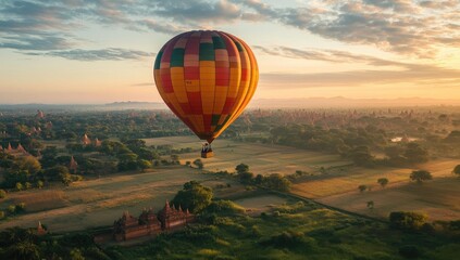Fototapeta premium Hot air balloon over ancient temples at sunrise.