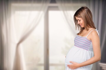 Pregnant woman smiling, expressing happiness