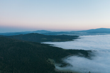 Mountain landscape with fog and distant hills