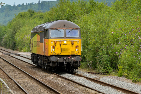 Pontyclun, Wales, UK. - 31 July 2024:  Class 56 diesel locomotive operated by Colas Rail Freight running alone without trucks near Pontyclun in south Wales.