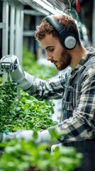 Fototapeta premium A farmer prunes plants while collaborating with a robotic assistant in a sophisticated greenhouse environment