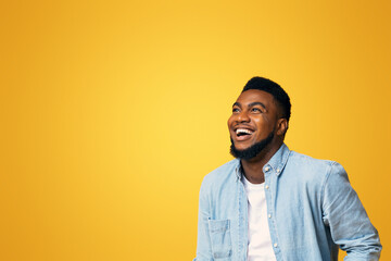 Awesome sales. Ecstatic african american guy looking up at copy space with amazement, isolated on...