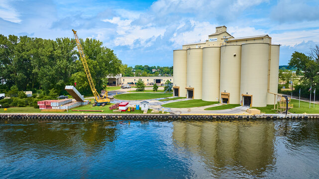 Aerial View of Industrial Silos and Crane by Waterfront