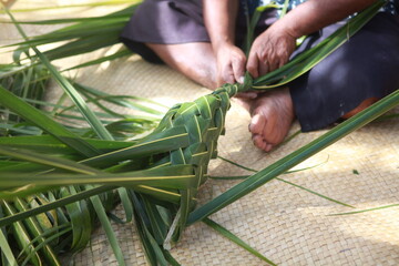 Fijian traditional basket weaving from palm leaves, men's basket demonstration, Fiji