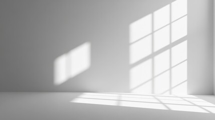 A minimalist interior with shadows cast by windows on a plain surface.