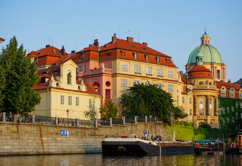 Buildings by the river against sky