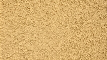 Warm beige stucco house exterior wall with subtle texture and soft shadow creating a serene and inviting background for various design projects.