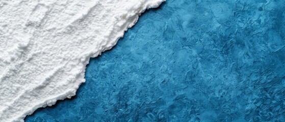 A tight shot of an ice chunk on a blue backdrop, displaying a distinct white line at its margin
