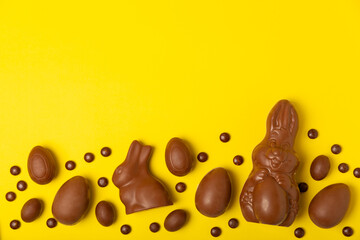 Easter chocolate egg. Easter celebration concept. Happy Easter. Chocolate sweet eggs. Candies on textured wooden table. Space for text.Copy space