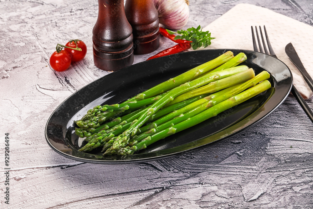 Wall mural vegan cuisine - boiled asparagus with oil