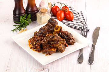 Prepared tasty beef ribs with sauce