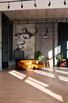 Modern loft living room with high ceiling, black and grey walls, wooden floor, design furniture and tropical plant.