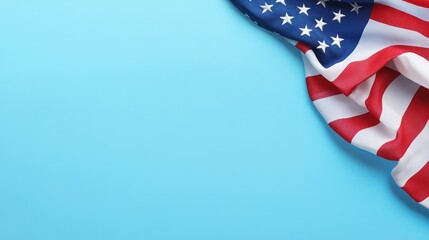 Obraz premium American flag draped elegantly on a bright blue background, symbolizing patriotism and national pride.