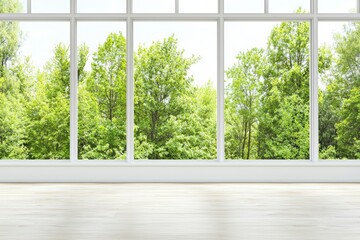 Bright and airy interior with large windows showcasing lush green trees outside, perfect for nature-inspired designs.