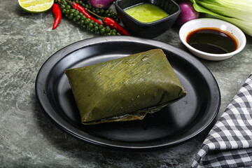 Asian cuisine - rice with filling in banana leaf