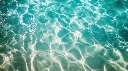 A serene turquoise water surface reflecting light, creating a calming and inviting atmosphere.