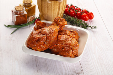 Raw turkey shoulder wing in Indian tandoori marinade
