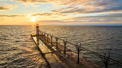 Aerial View of Lighthouse on Pier at Sunset