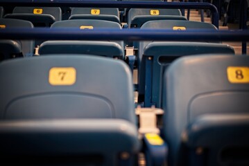 Empty Stadium Seats with Numbered Rows