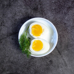 Halved Boiled Eggs on Plate - Top View with Copy Space