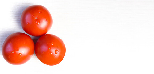 Ripe Tomatoes on Light Background with Copy Space