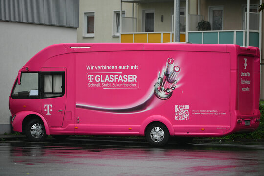 Goslar, Germany - August 19. 2024: Deutsche Telekom advertising vehicle for advertising on the subject of fiber optic expansion