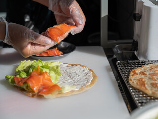 Chef prepares flatbread with salmon.Quesadilla. 