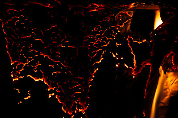 burning paper, glowing edge of paper on a black background.