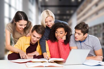 Group of teenage happy students study in classroom library