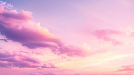 Obraz premium A serene sky at sunset with soft pink and purple hues blending with clouds.
