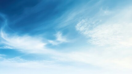 Obraz premium A serene sky with soft clouds and a gradient of blue tones.