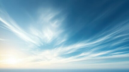 Fototapeta premium A serene sky with wispy clouds and a soft sunlight glow, evoking tranquility and peace.
