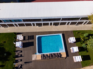 Panoramic aerial drone view of swimming pool in hotel. Summer holiday in Europe.