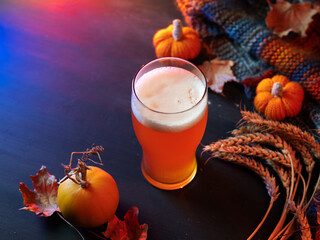 Seasonal pumpkin ale beer for Thanksgiving. Craft beer. Orange pumpkin, wheat ears and autumn leaves. Copy space