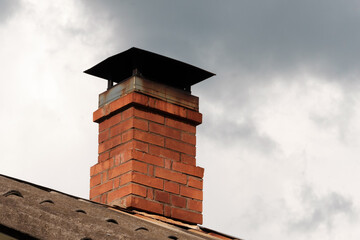 A brick chimney is currently resting on the top of a roof structure