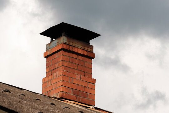 A brick chimney is currently resting on the top of a roof structure