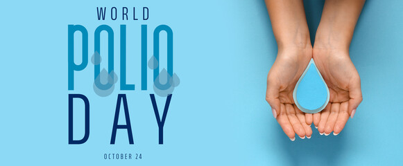 Female hands with paper drops on blue background. World Polio Day