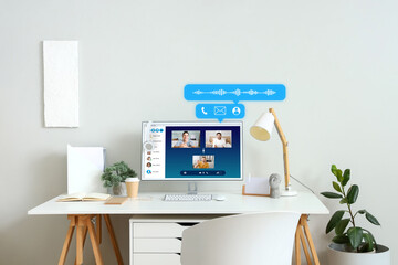 Comfortable workplace with modern computer near light wall