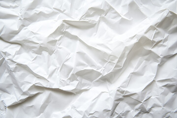 Obraz premium Crumpled white paper texture with various folds and creases, creating an abstract and intricate pattern across the surface.