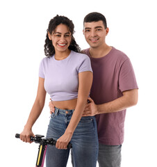 Fototapeta premium Beautiful young couple with modern electric kick scooter on white background