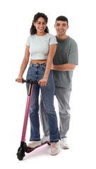 Beautiful young couple riding modern electric kick scooter on white background